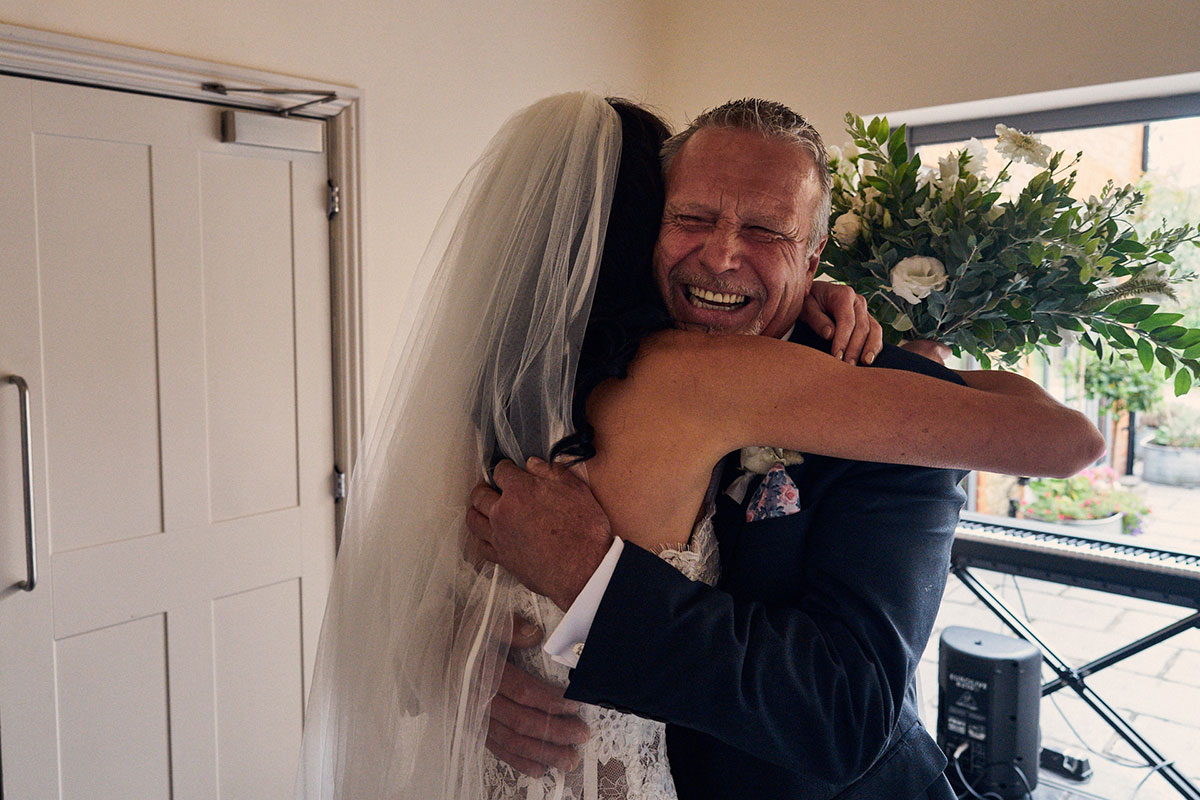 Happy father of the bride hugging his daughter