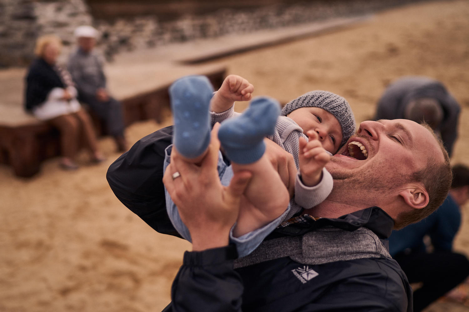 dad playing with his son on the beach