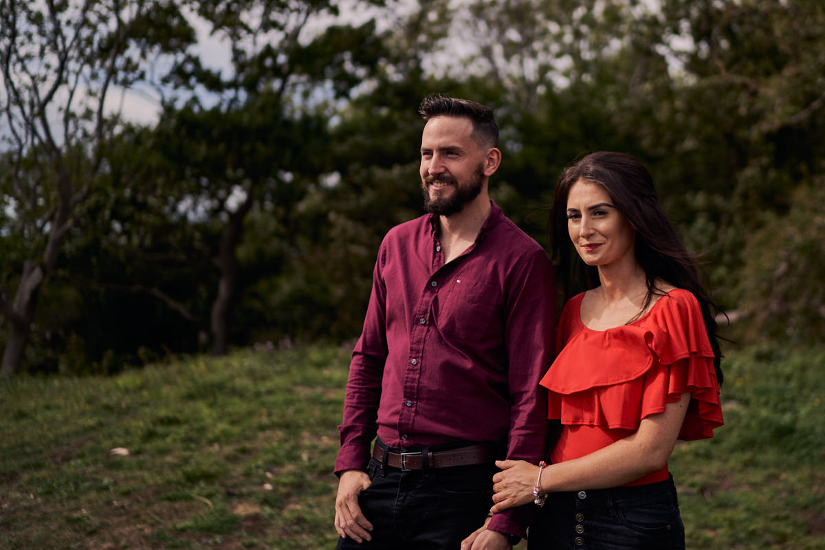 couple holding hands at the top of a hill