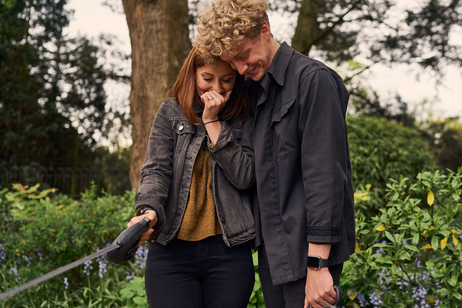 newly engaged couple hugging in Fletcher Moss Park, Manchester
