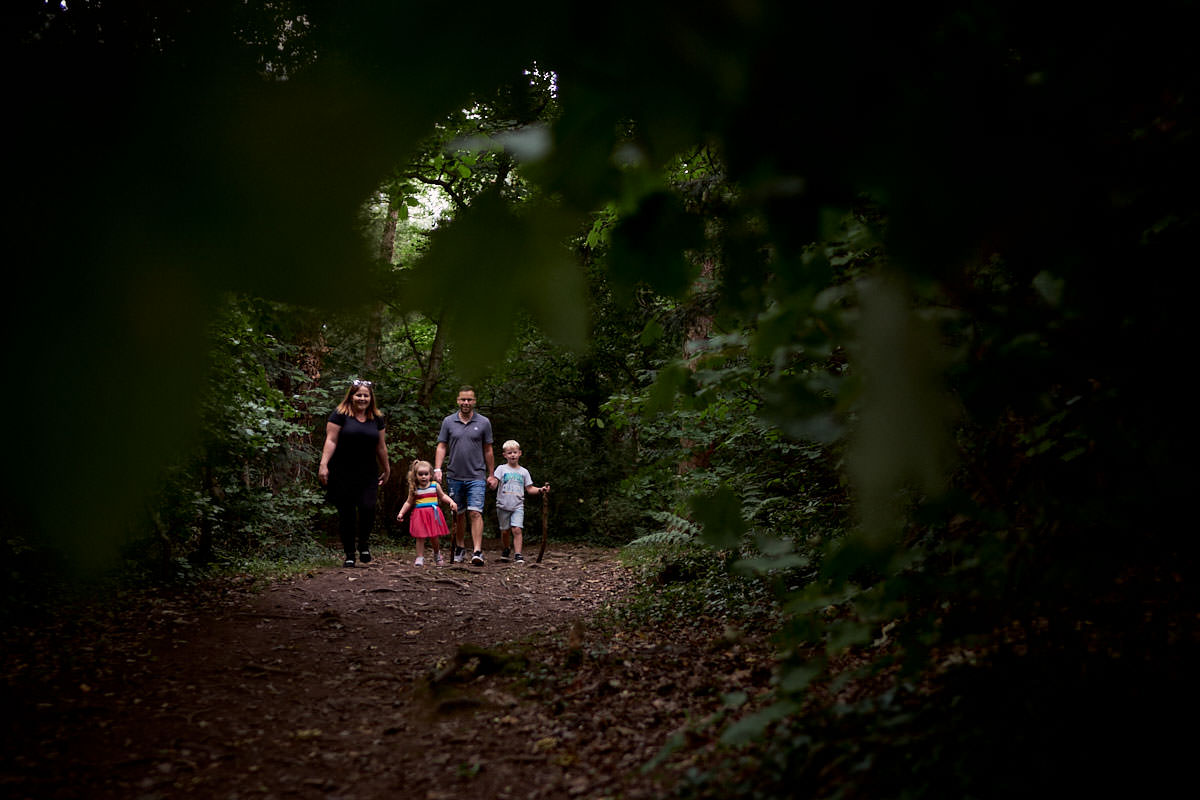 family exploring in the woods