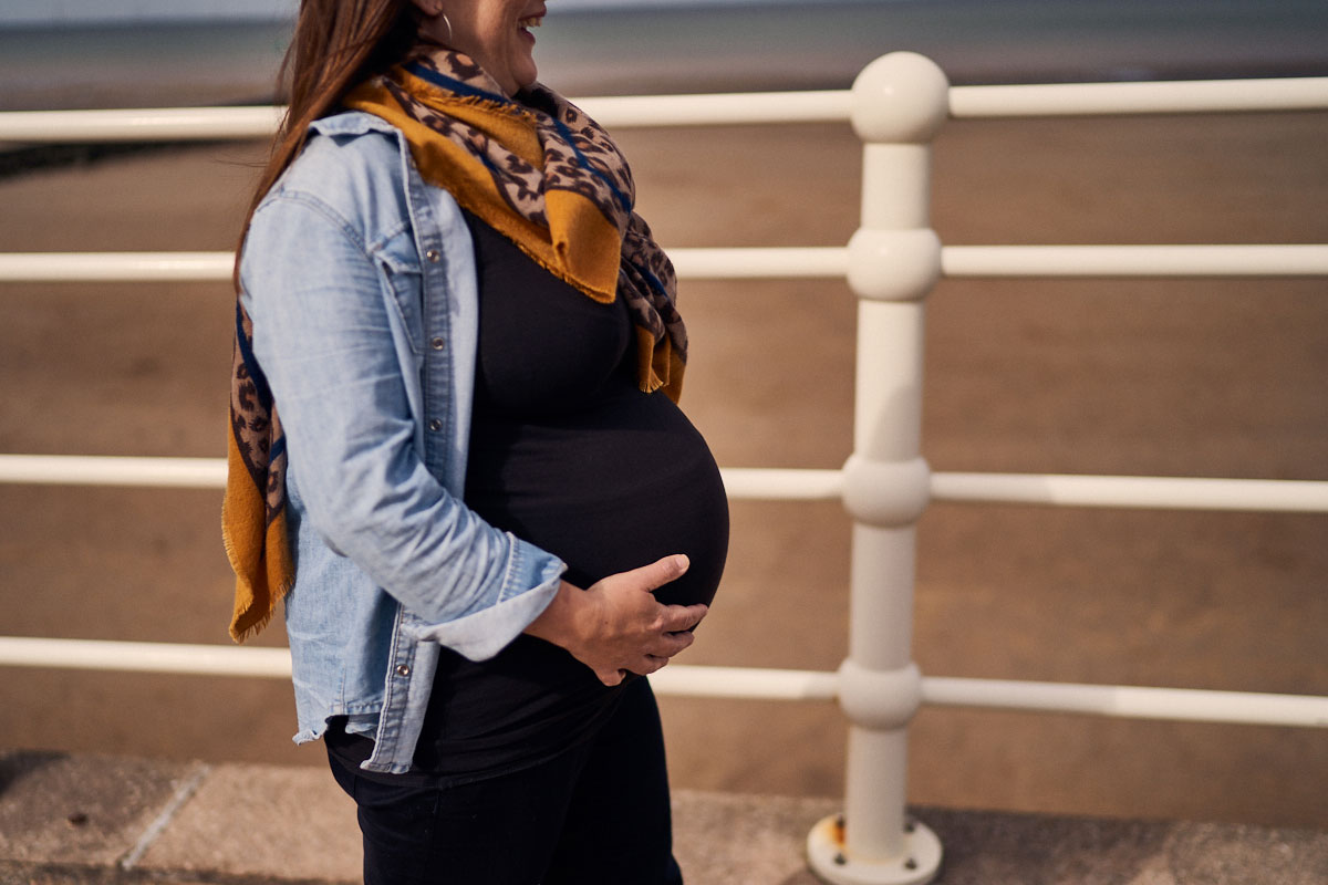 pregnant mother holding her bump