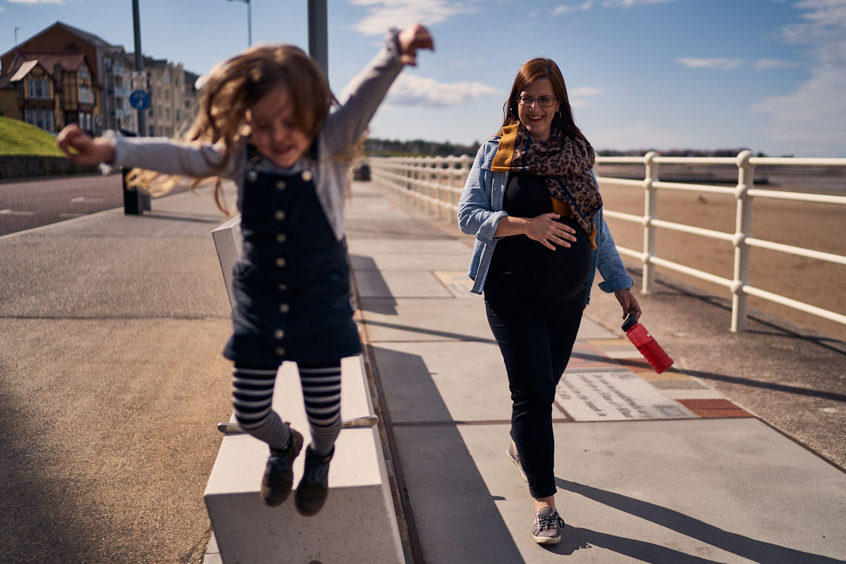 pregnant mum walking with her daughter