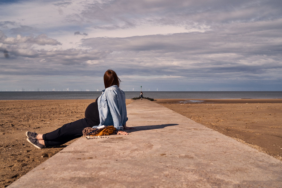 pregnant mum resting on the beach