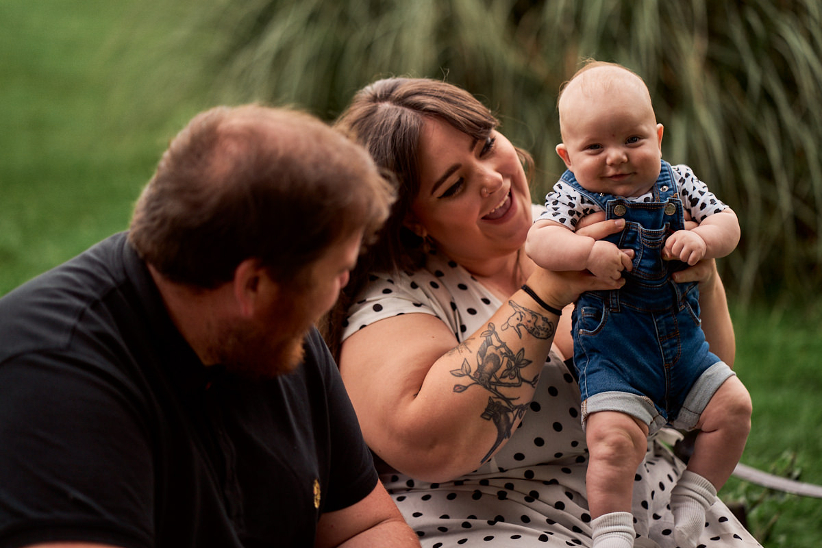 new parents playing with their baby