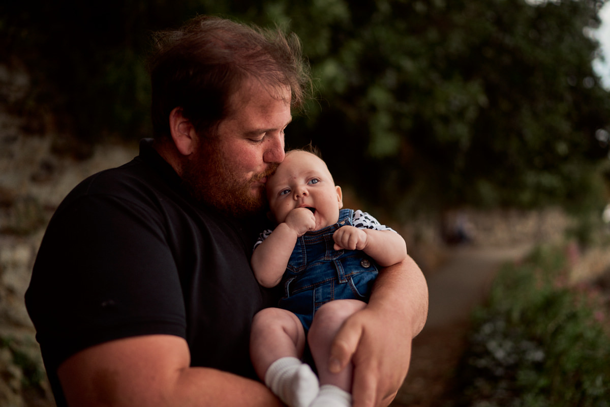 dad kissing his baby boy