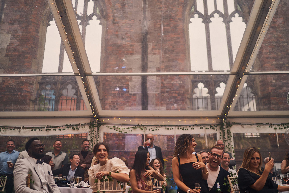 guests laughing at surprise birthday party