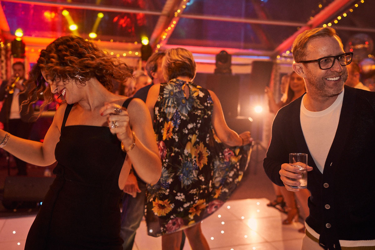 husband and wife dancing at her surprise birthday party