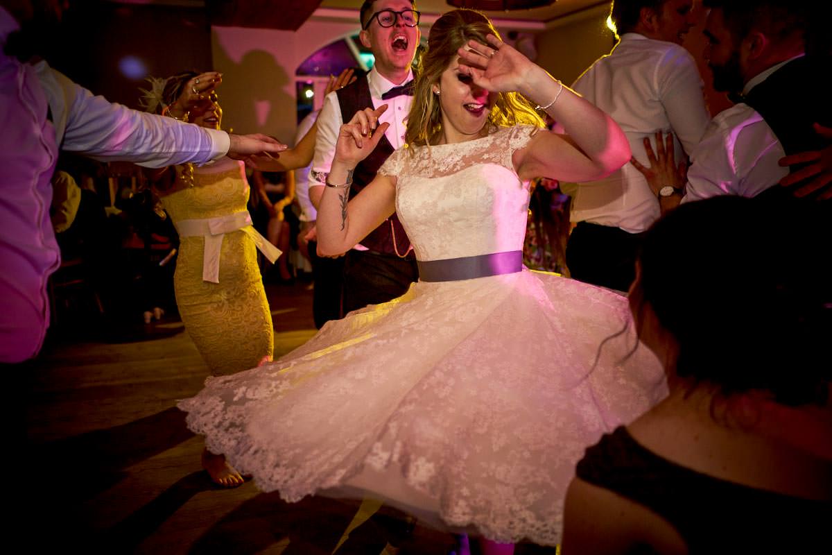 Bride twirling and spinning her short wedding dress