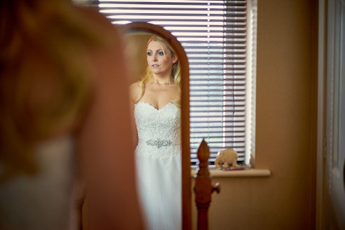 bride in wedding dress in mirror