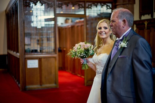 father of the bride walking down the isle with bride