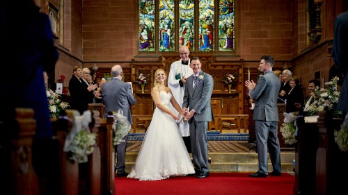 bride and groom at the alter