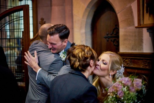 bride and groom being congratulated after getting married
