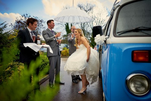 bride and groom getting out of VW Camper Van