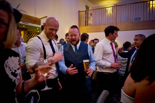 Wedding guests having a pint