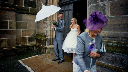 Bride, Groom, Mother of the Bride and an umbrella