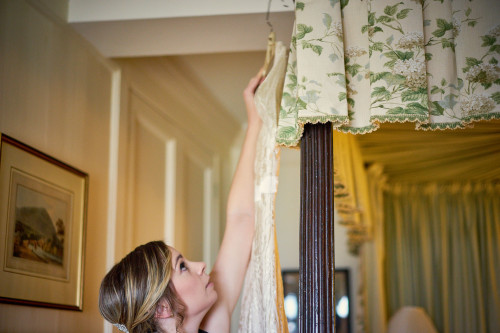 bride hanging wedding dress up