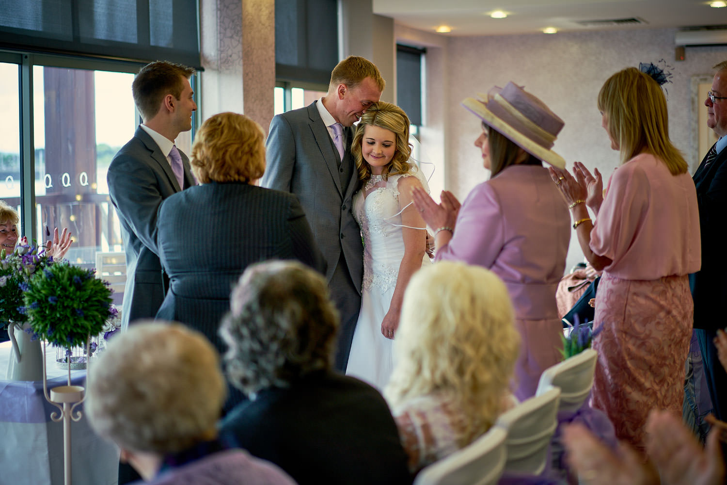 groom hugging bride