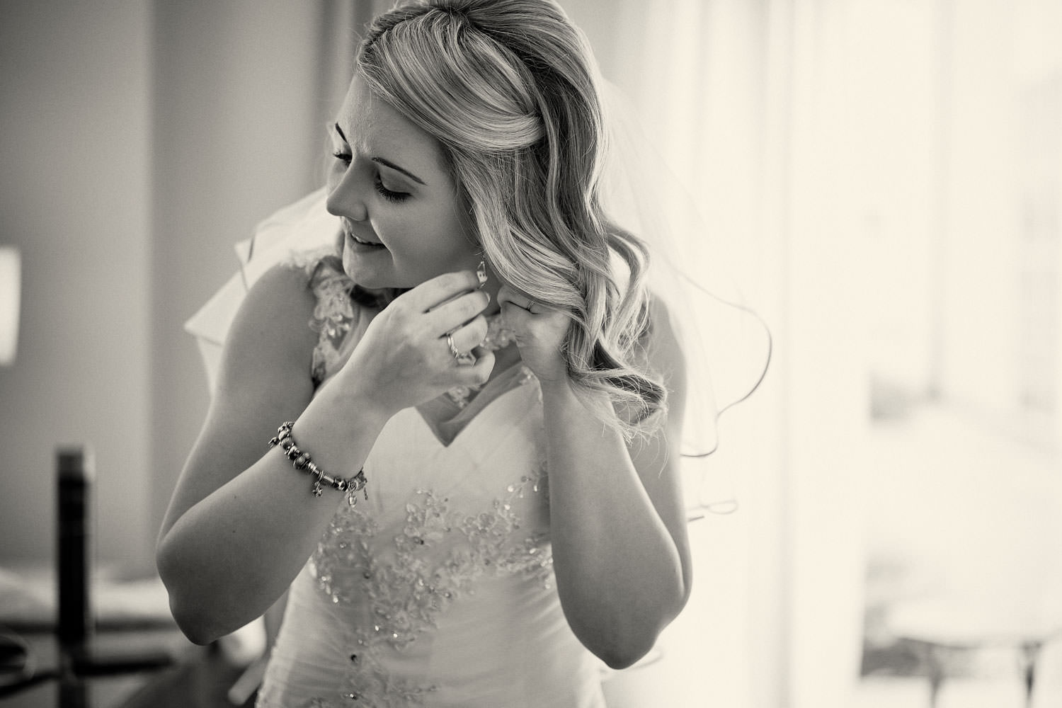 bride putting her earring in
