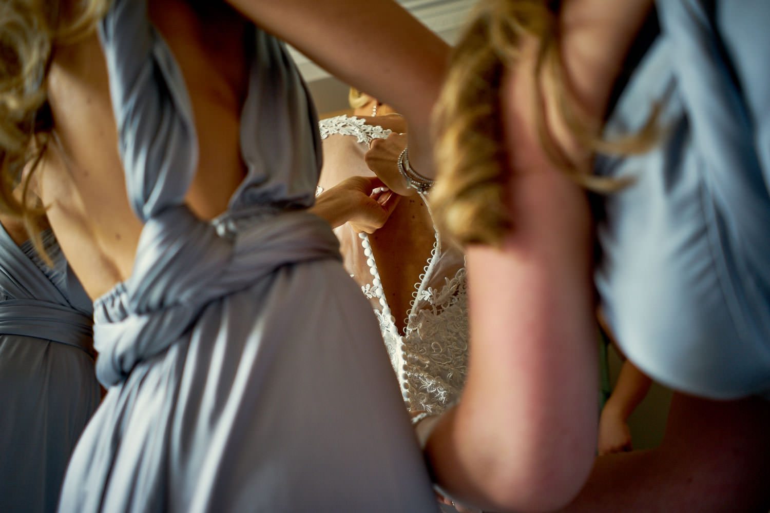 brides dress being done up