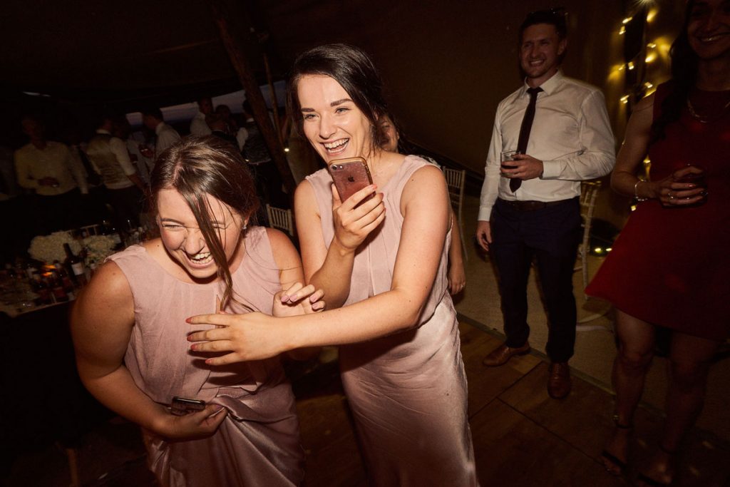 Bridesmaids laughing on the dance floor