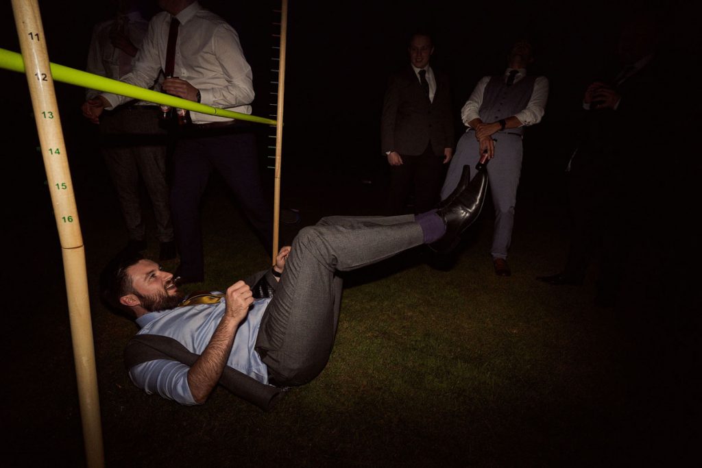 wedding guest falling over trying to limbo drunk
