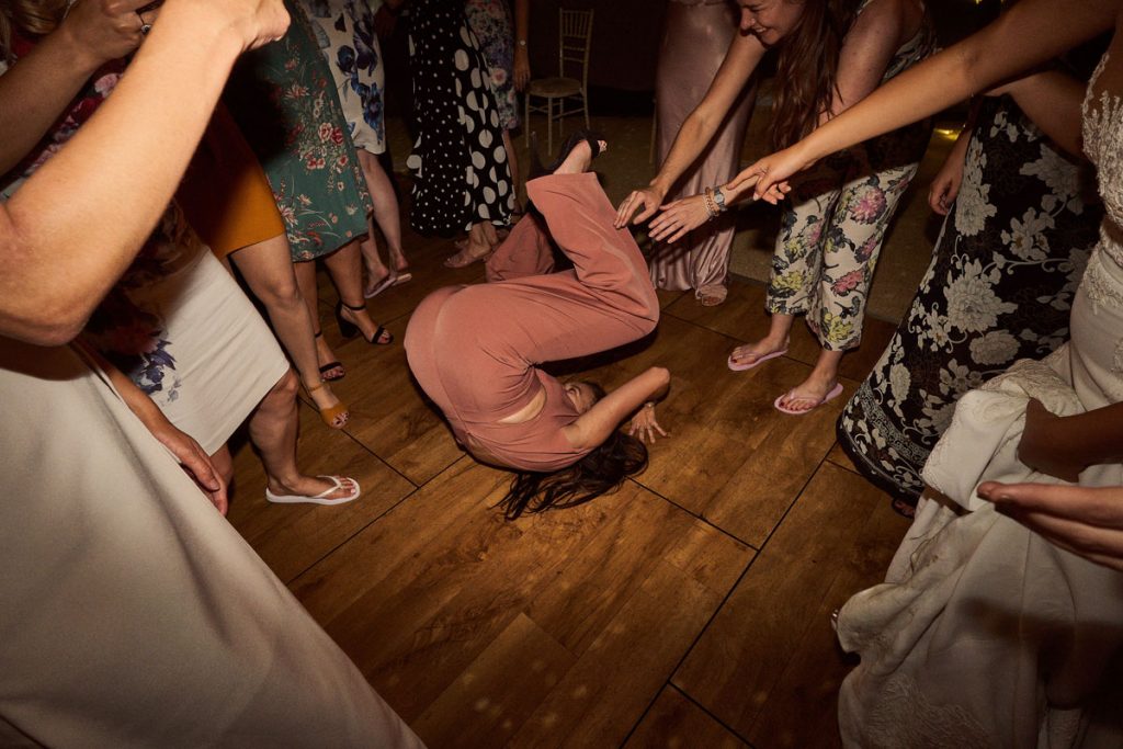 wedding guest doing a forward roll on the dance floor