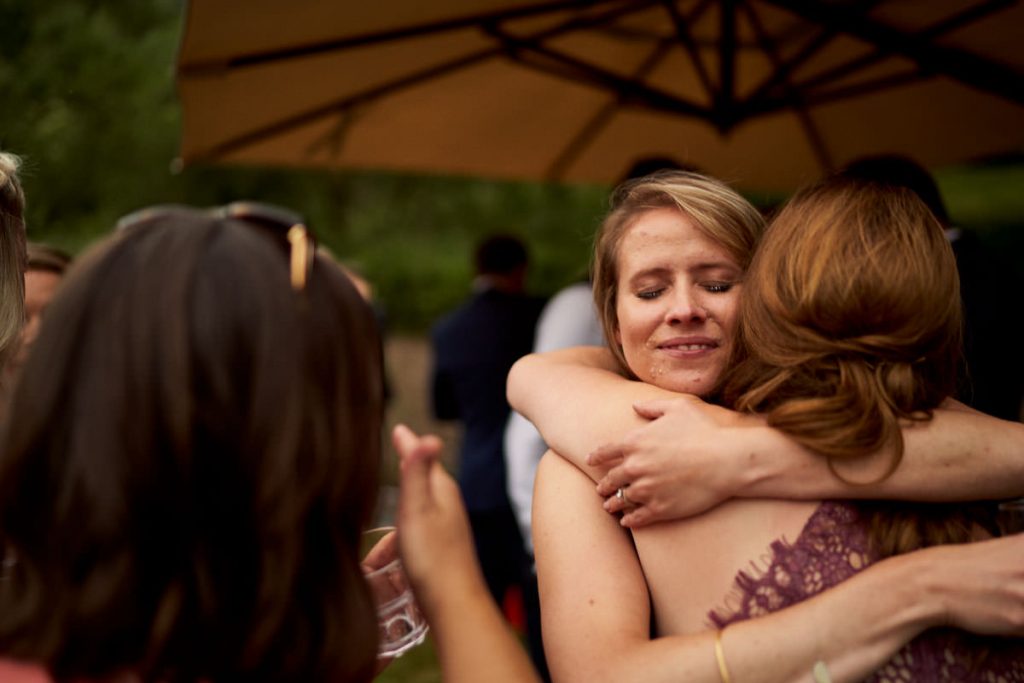 bride hugging best friend after speeches