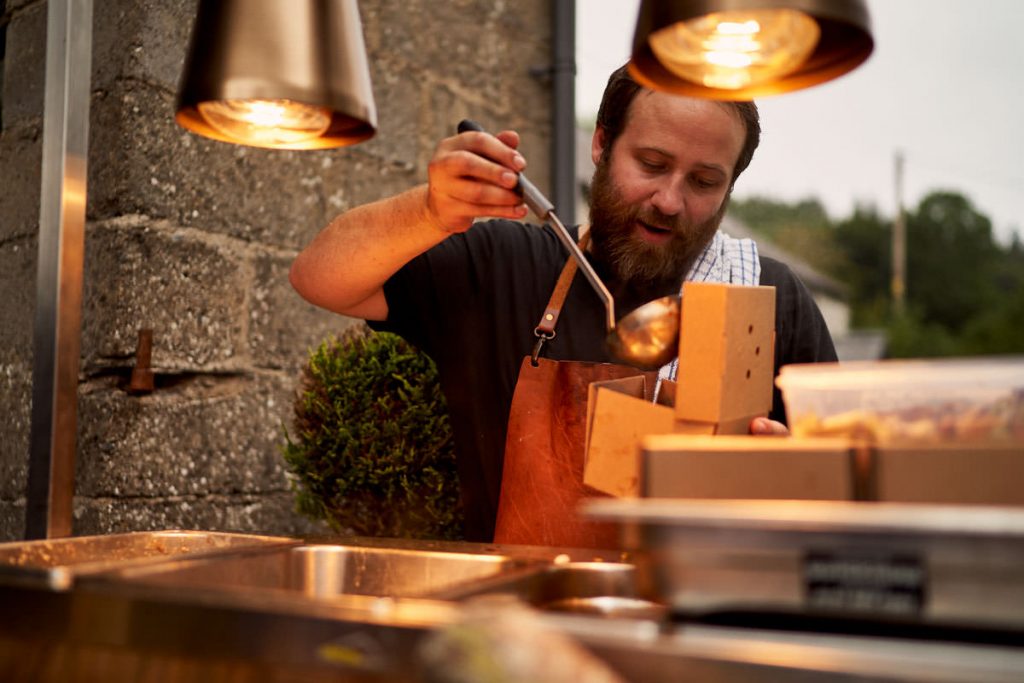 chef dishing up relaxed street food at wedding