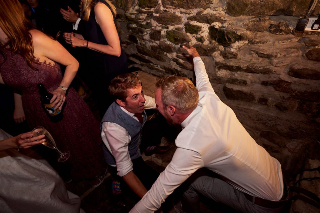 groom drunken dancing with wedding guest
